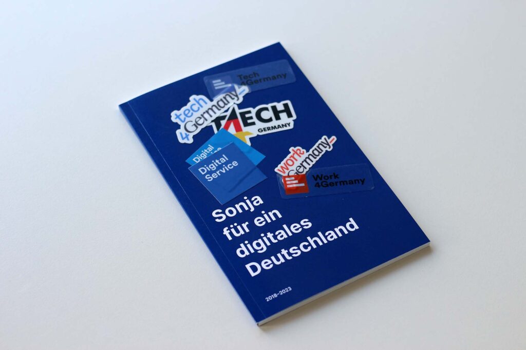 A small booklet with various colourful stickers from Tech4Germany, Work4Germany and DigitalService – on its cover, it says ‘Sonja for a digital Germany’